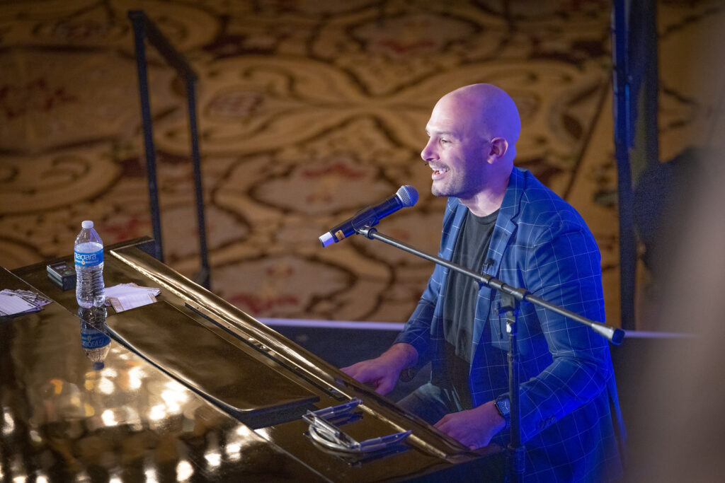 a piano player engaging the audience at a performance